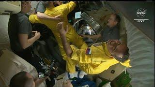 Russian crew arrives on board the ISS wearing yellow and blue | AFP