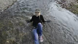 Wetlook - Kelevra in river with red converse, jeans and sweater.