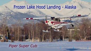 Landing on Ice - Piper super cub lands on frozen Lake Hood, Alaska.