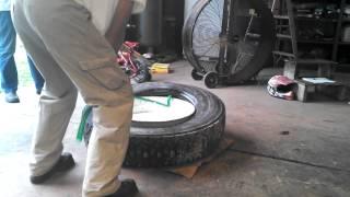 Dismounting a truck tire using Ken tool serpent.