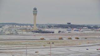 Video: Snow plows working to clear Atlanta airport runways