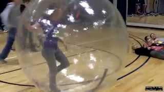 Girl in a giant Hampster ball trampling boys