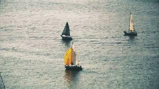 Sailors of the Sky: Drone Footage of Sailboats Gliding on Water 