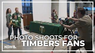 Timbers fans pose with team's iconic ax for stadium arch display