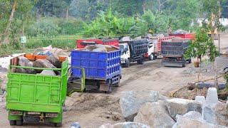 Dump Trucks queue to unload rocks with excavators