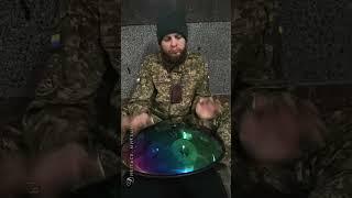 A Ukrainian soldier MAG let's play handpan in an underground passage near the entrance to the subway