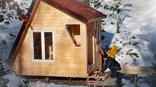 A wooden house in the middle of the forest. Construction in winter