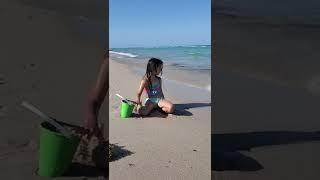 Kids playing on the beach with sand and having fun. South Beach Miami 