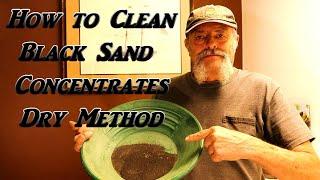 Cleaning up black sand concentrates from a day out mining for gold  - dry method