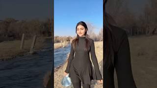 Village Life: Uyghur Girl Fills a Water Cube from the River in Winter