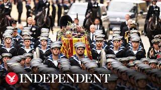 Sailors pulling gun carriage carrying Queen's coffin arrive at Westminster Abbey