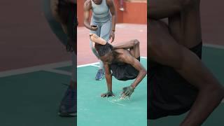 Fastest 10 m walking on the hands with legs behind the head ⏱️ 12.52 seconds by Anjola Olupitan 